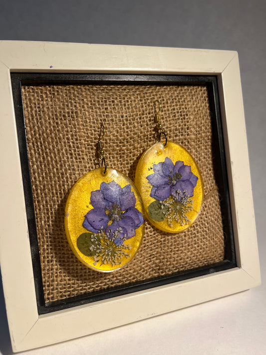 Golden Oval Pendant Earrings with Large Violet and Tiny White Flowers