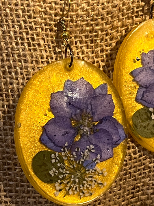 Golden Oval Pendant Earrings with Large Violet and Tiny White Flowers